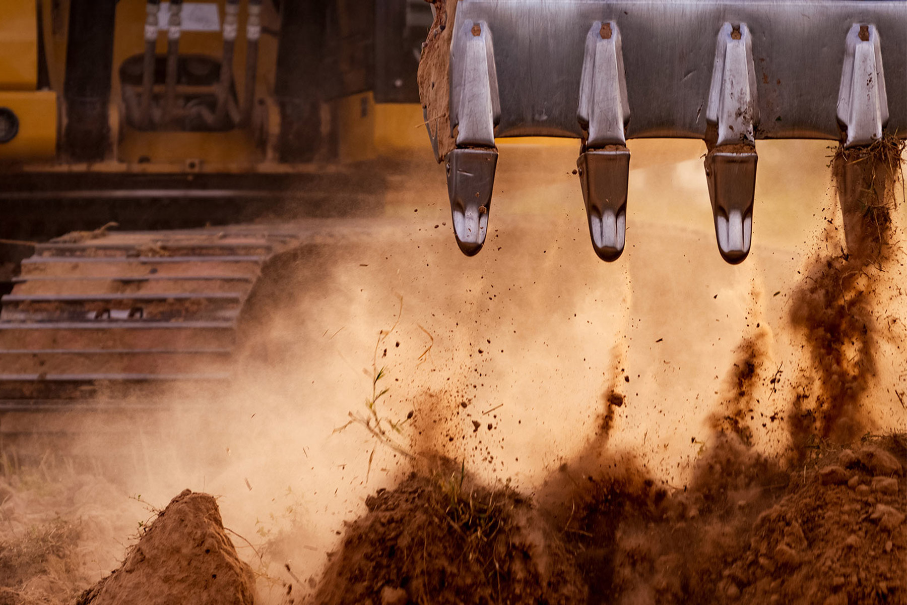 excavation machine excavating dirt at construction site mertzon tx